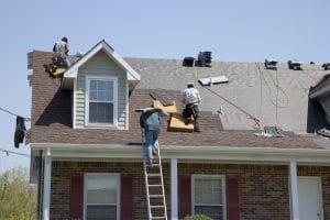 Roofers replacing damaged shingles in macon